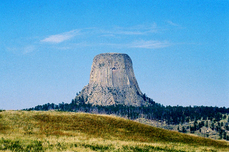 [Devil's Tower from a long distance with the entire rock visible.]